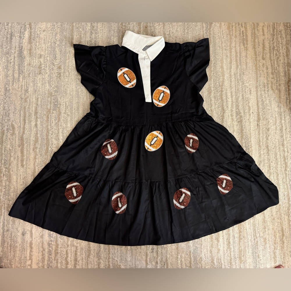Black dress with footballs appliqué. Some are some are sparkly. Size XXl